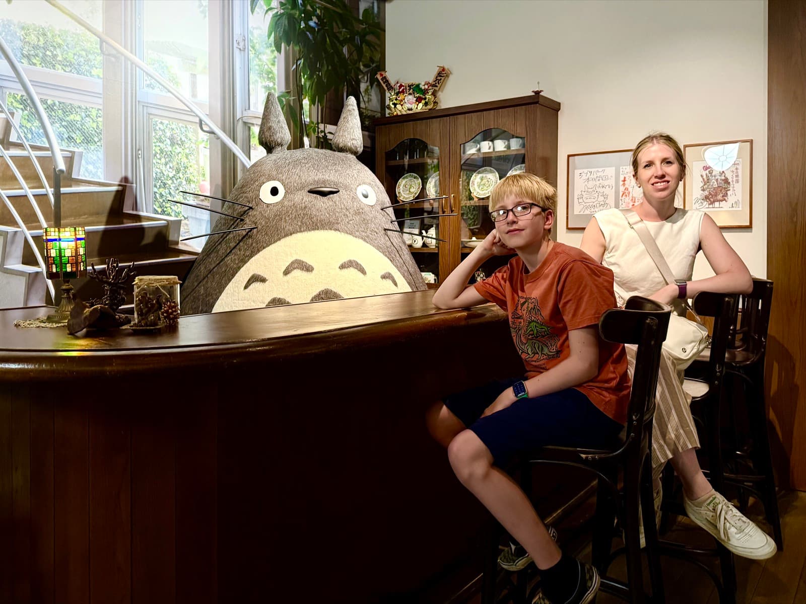Owen and Jill sitting with a large Totoro at Ghibli Park